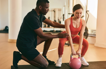 Working with a corrective exercise client after performing structural assessments and movement analysis